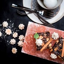 Brownie with coffee meringe on hot pink salt block