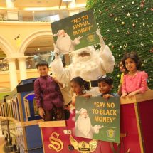 Santa posing with the kids and spreading the message Say YES to white money at Growels 101 Mall - Kandivali east