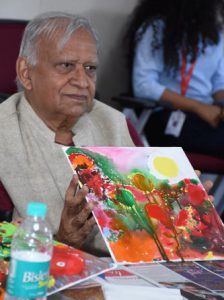 Cancer survivor displaying his painting during the art therapy
