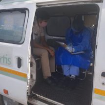 Medical professional from Fortis Hospital conducting basic COVID 19 screening on traffic personnel 3