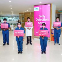 Aster CMI Doctors Holding Pink Placards